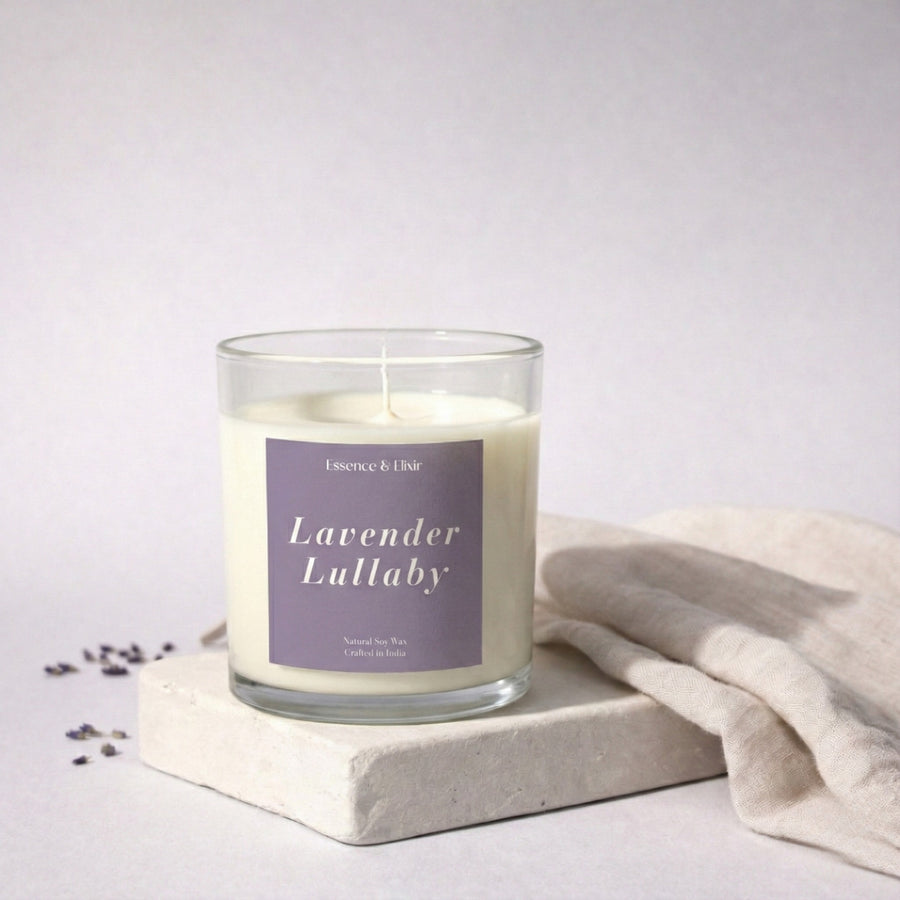 Candle labeled 'Lavender Lullaby' on a white surface with a light background
